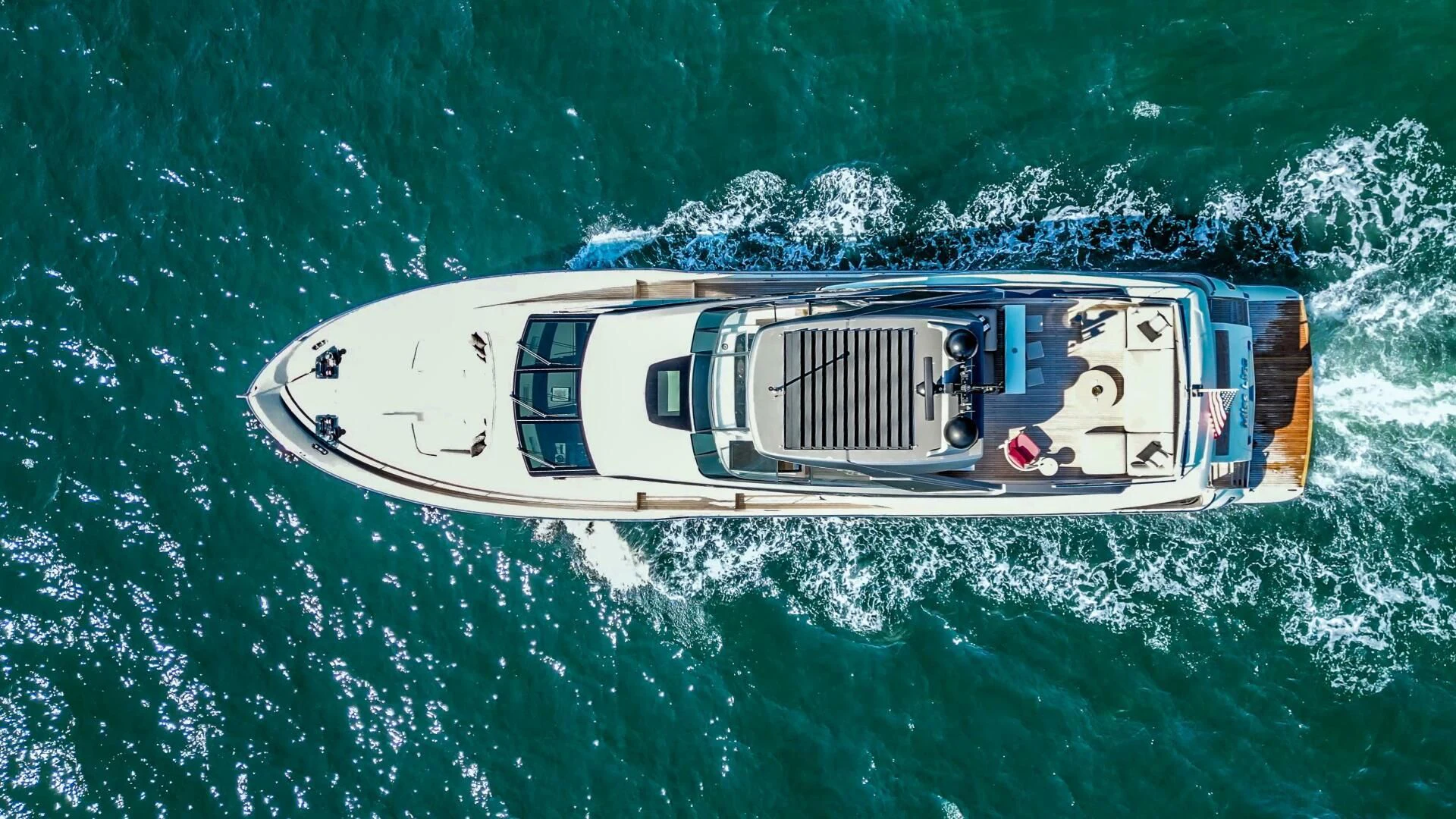 a white boat in the water aboard JUJU Yacht for Sale