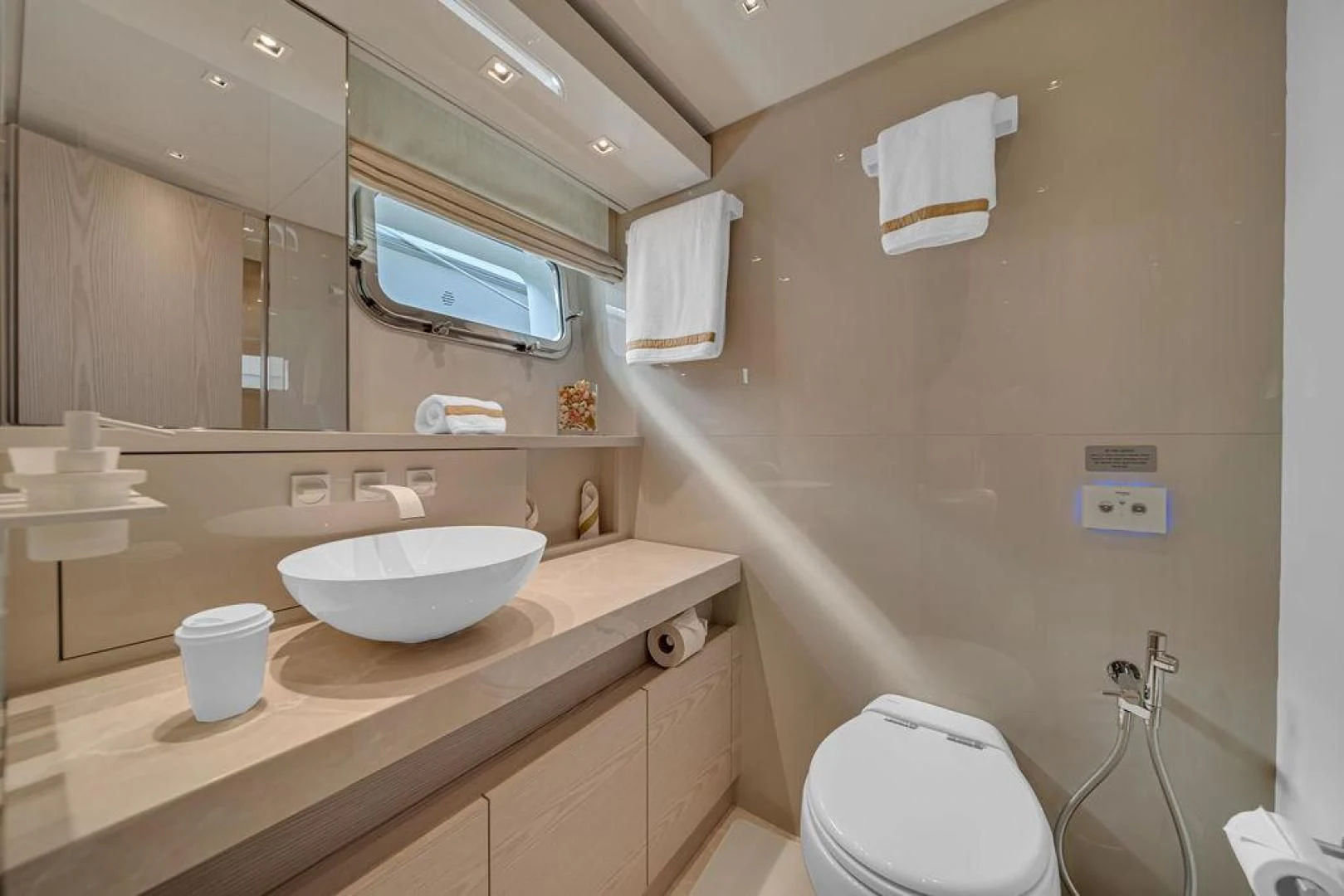 a bathroom with a sink toilet and a mirror aboard JUJU Yacht for Sale