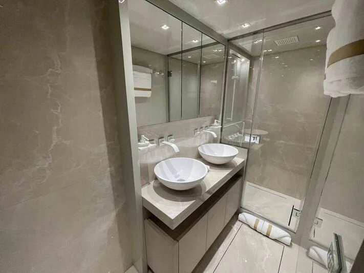 a bathroom with a sink and a mirror aboard JUJU Yacht for Sale