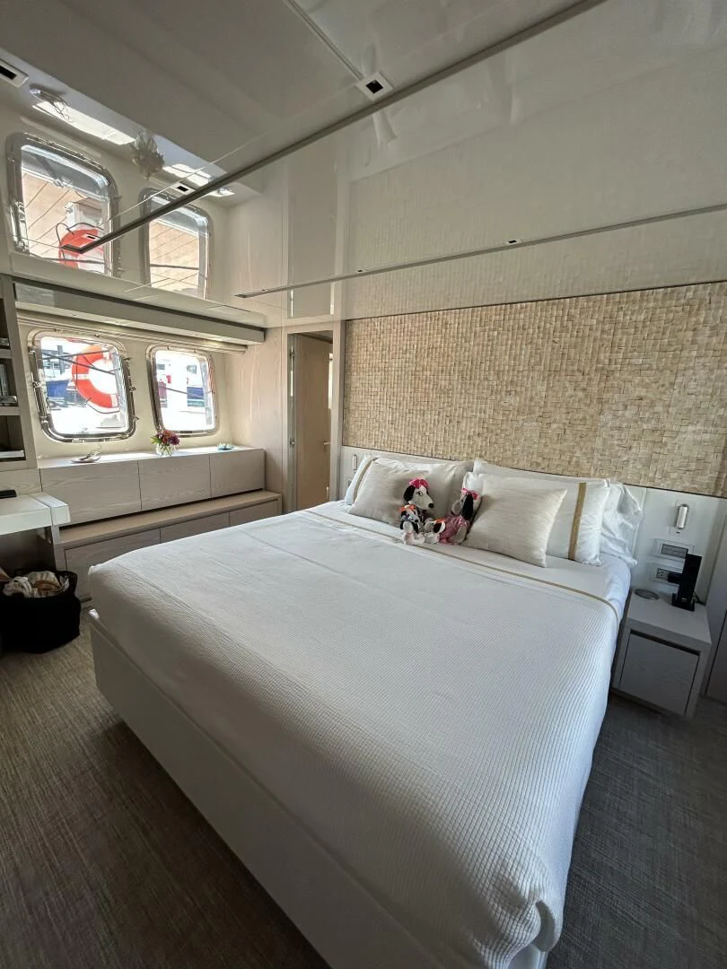 a bedroom with a large bed aboard JUJU Yacht for Sale