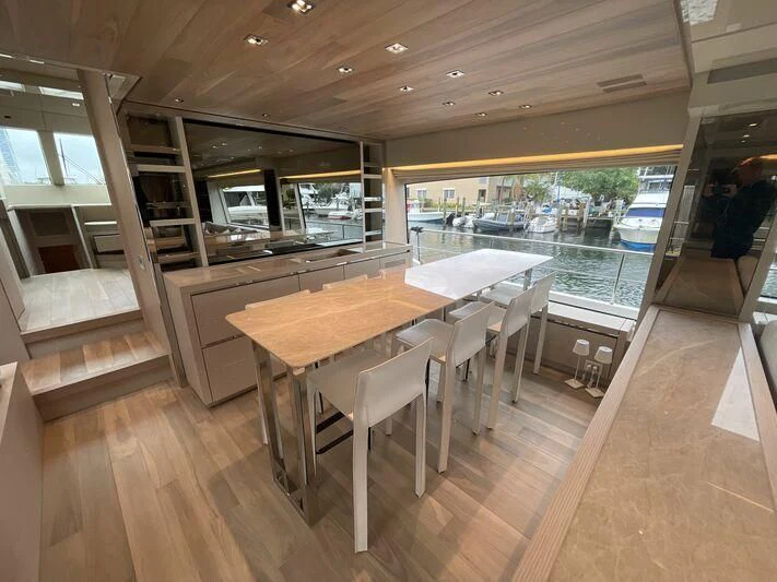 a room with tables and chairs aboard JUJU Yacht for Sale