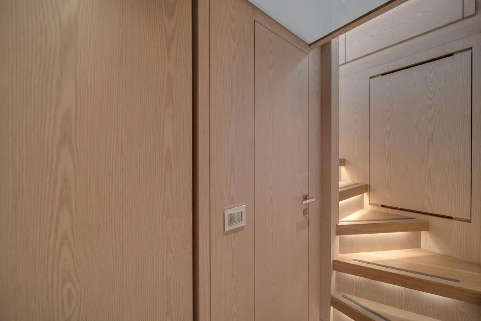 a room with wooden cabinets aboard JUJU Yacht for Sale