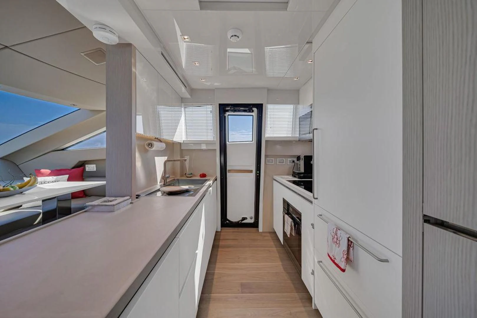 a kitchen with white cabinets aboard JUJU Yacht for Sale