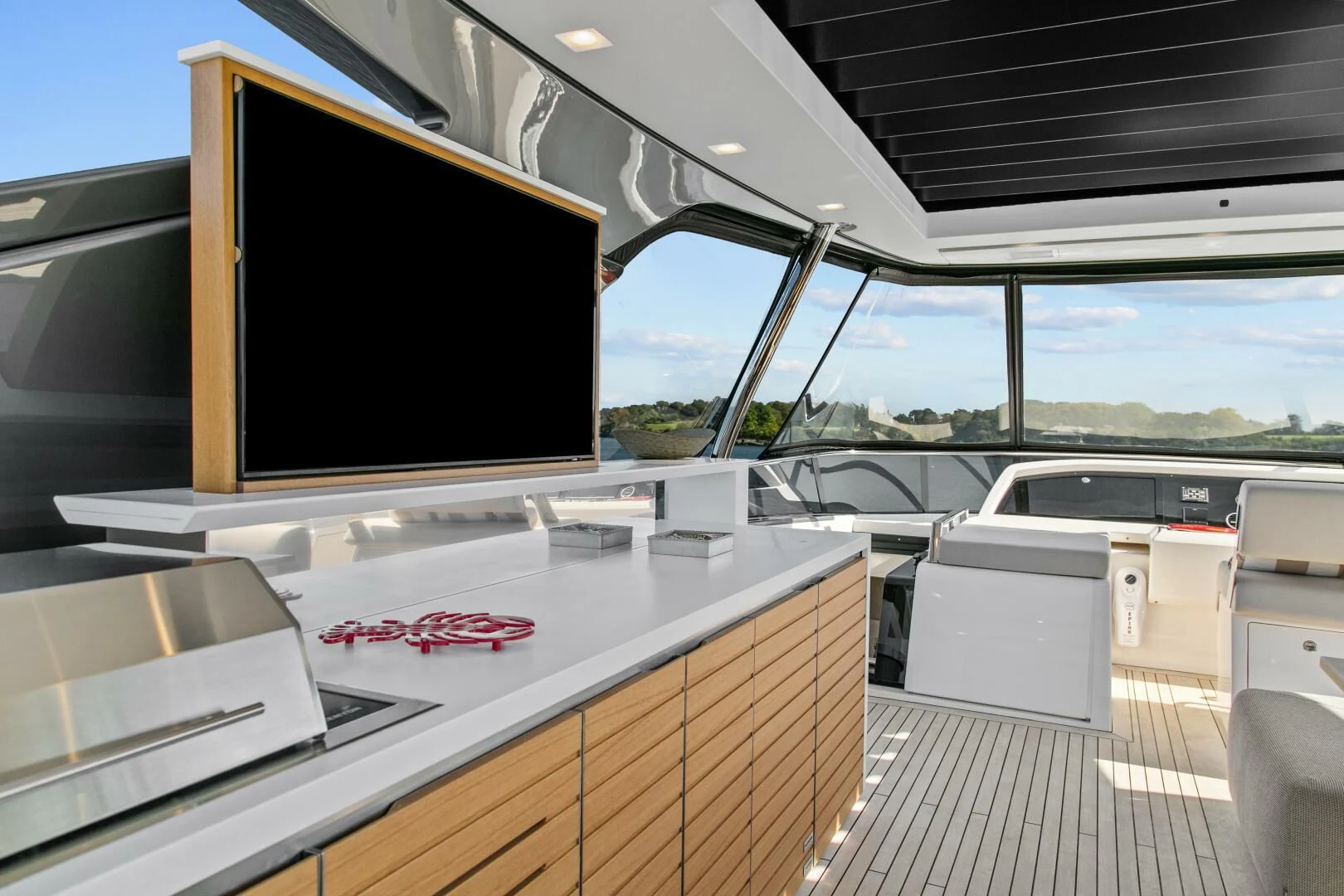 a large room with a tv and a large window aboard JUJU Yacht for Sale