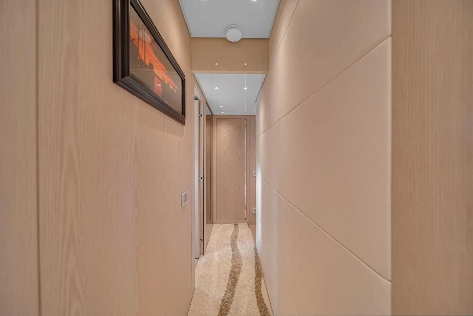 a hallway with a television on the wall aboard JUJU Yacht for Sale