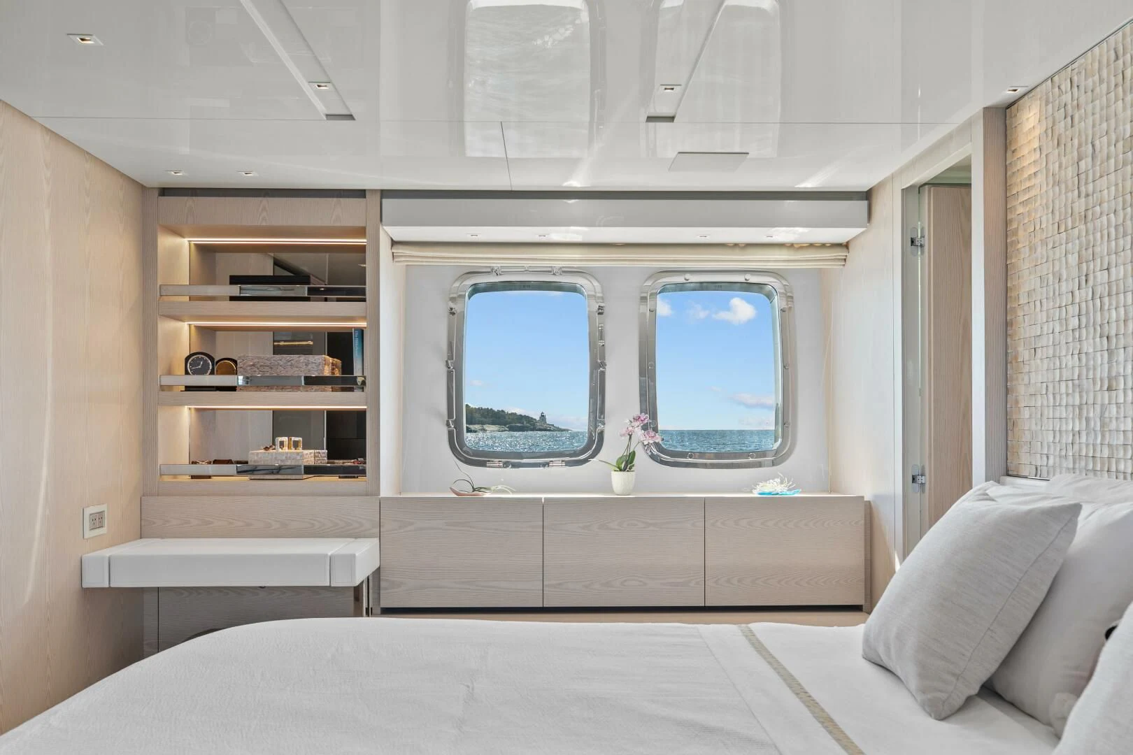 a room with a bed and shelves aboard JUJU Yacht for Sale