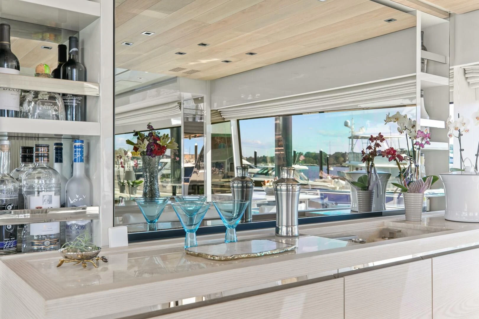 a kitchen with a lot of glass and flowers on the counter aboard JUJU Yacht for Sale