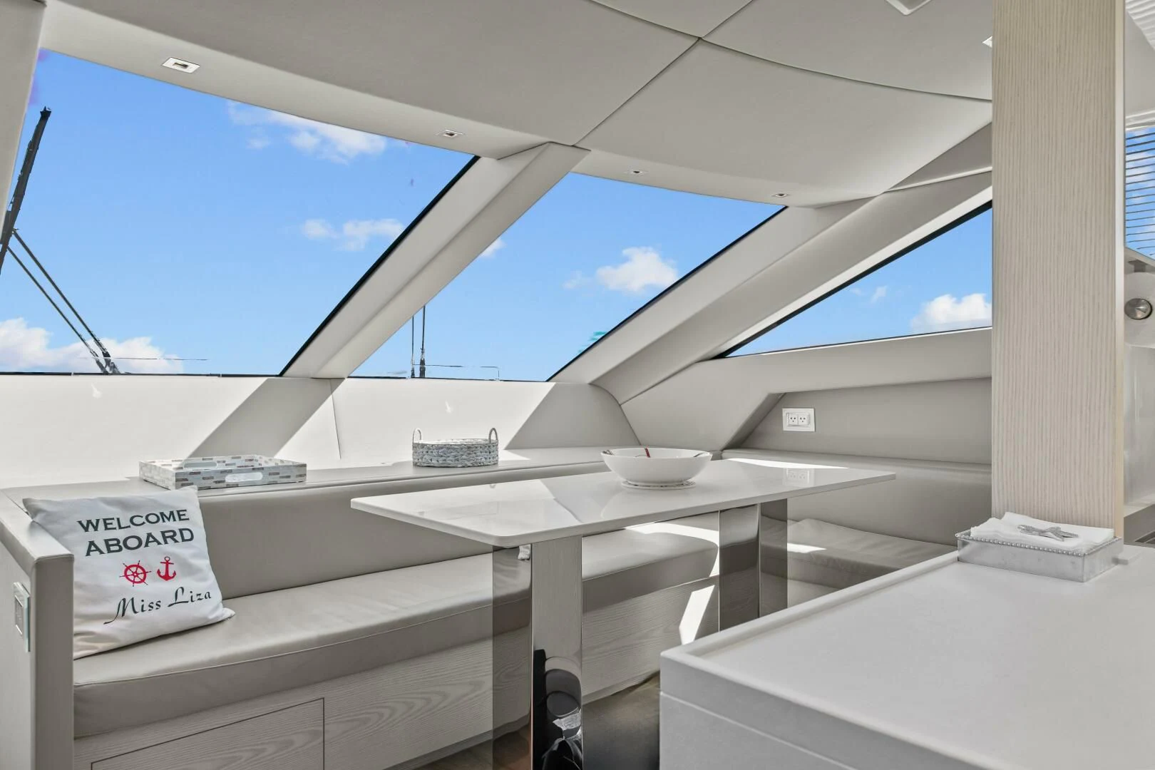 a white table on a balcony aboard JUJU Yacht for Sale