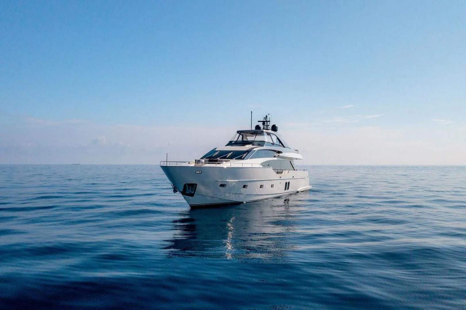 a white boat in the water aboard JUJU Yacht for Sale