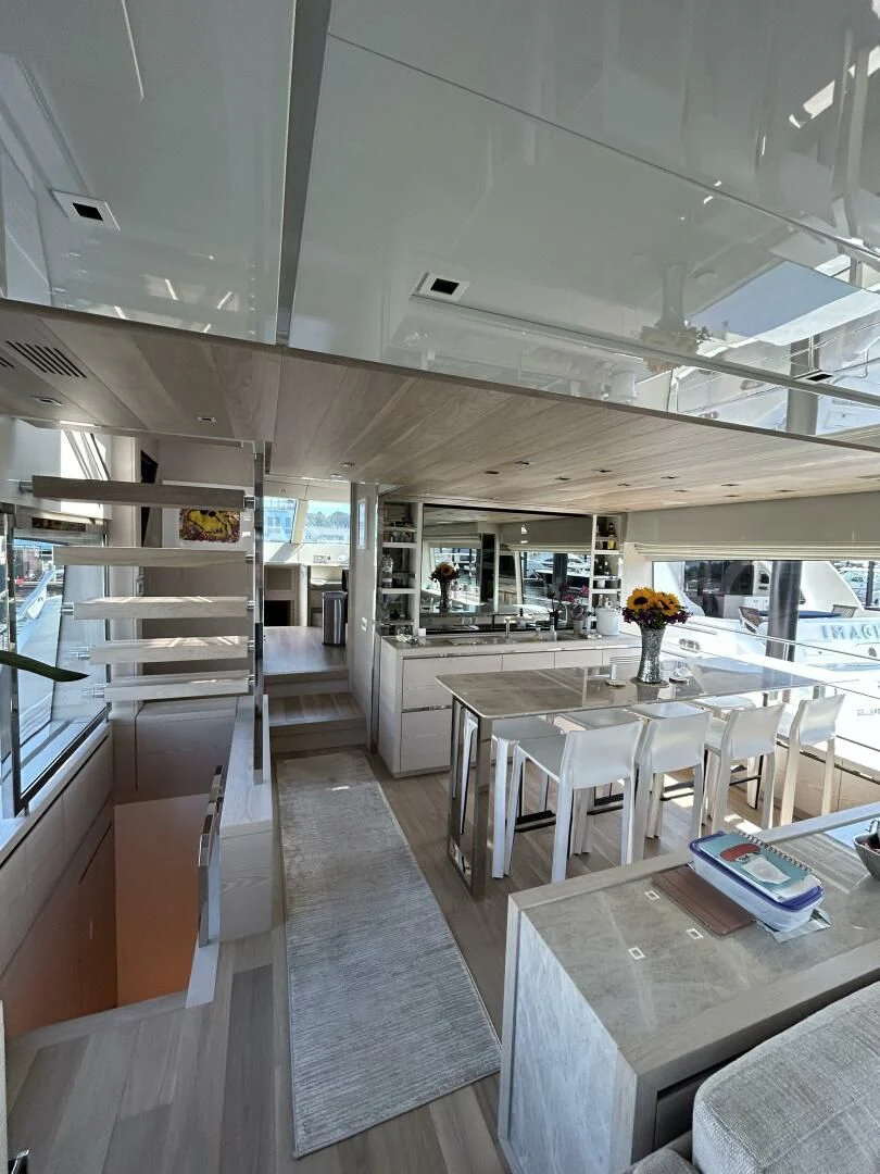 a room with a table and chairs aboard JUJU Yacht for Sale