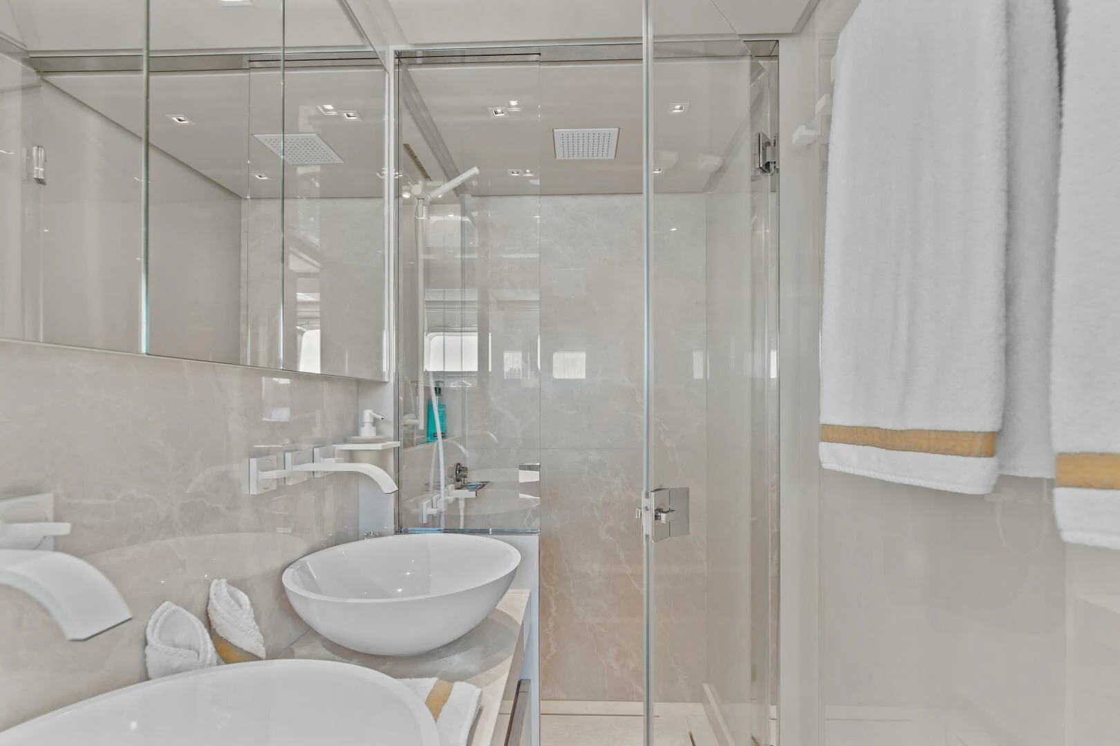 a bathroom with a glass shower aboard JUJU Yacht for Sale