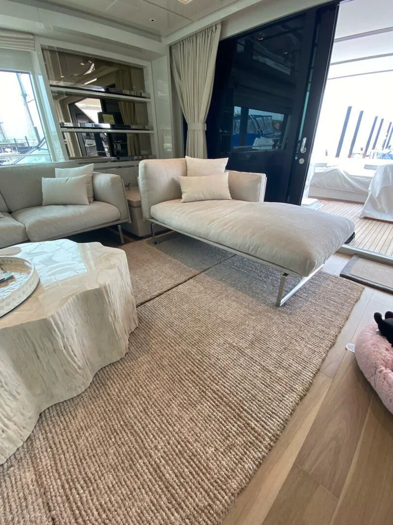 a living room with a couch and a table aboard JUJU Yacht for Sale