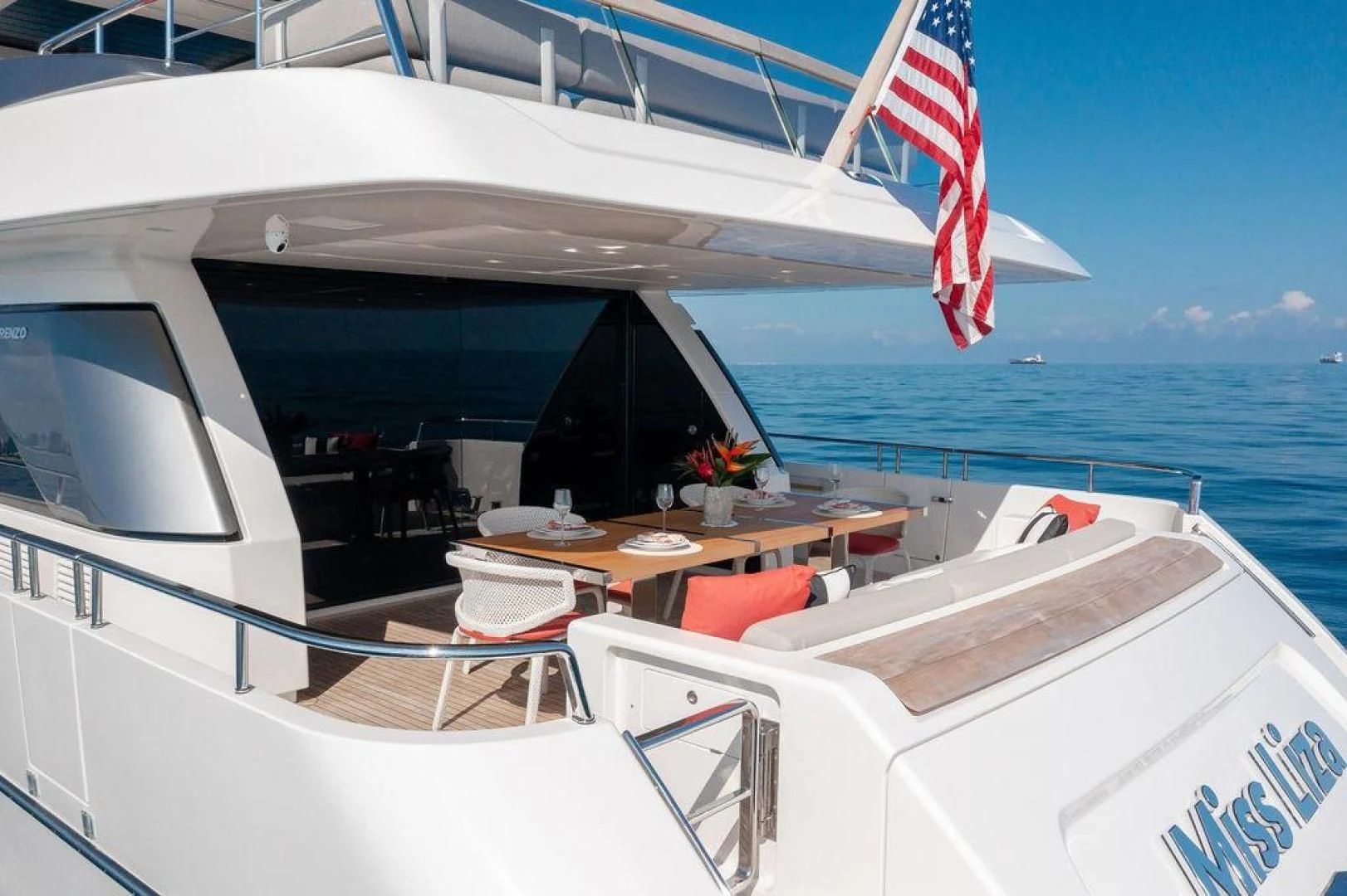 a boat with a flag on the front aboard JUJU Yacht for Sale