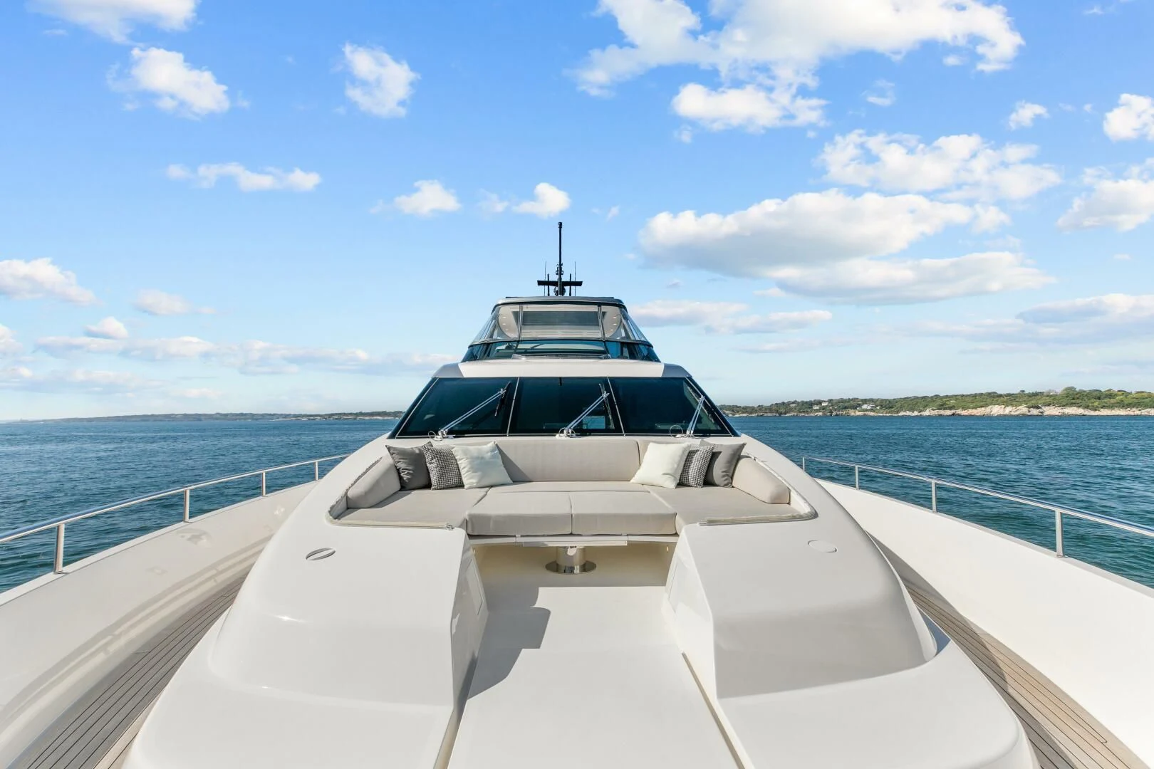a white boat on a body of water aboard JUJU Yacht for Sale