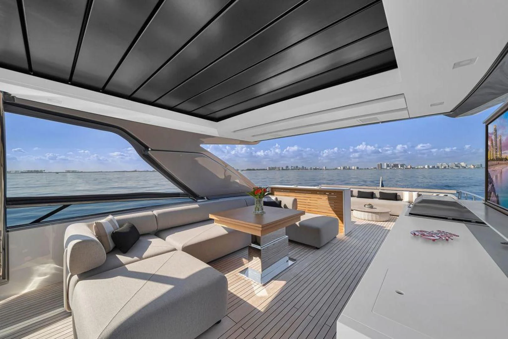 a room with a view of the ocean and a city aboard JUJU Yacht for Sale