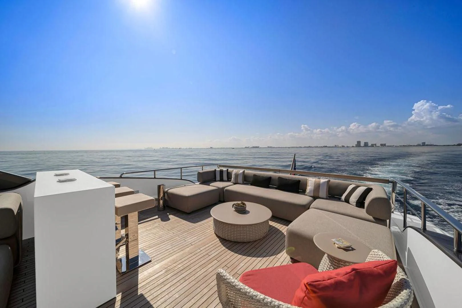 a deck with a view of the ocean and the city below aboard JUJU Yacht for Sale