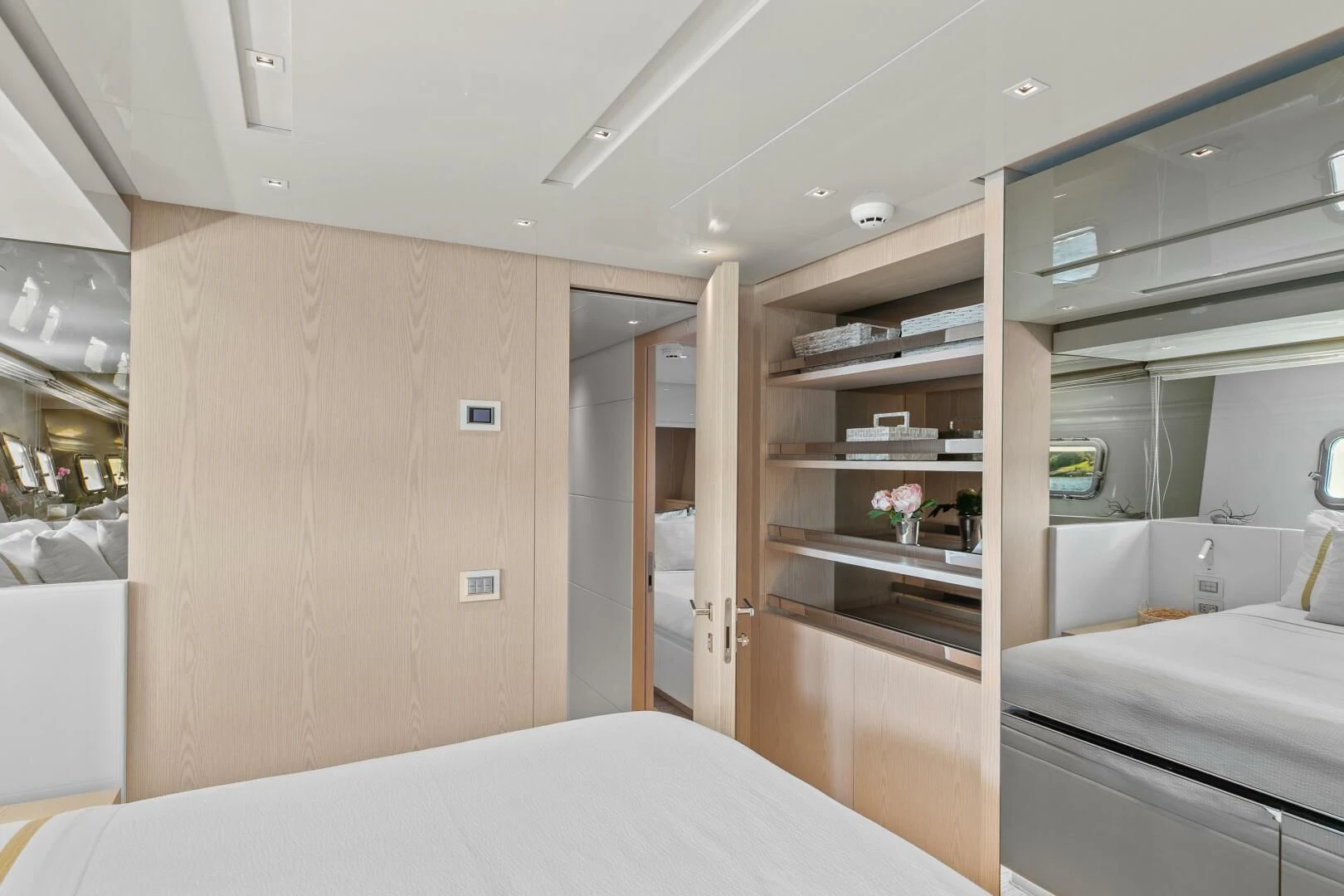 a room with a bed and a shelf with a mirror aboard JUJU Yacht for Sale