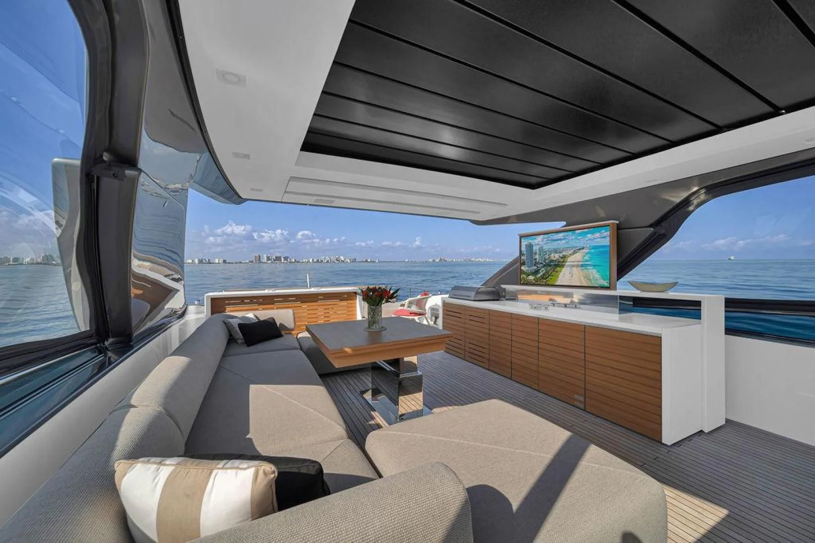 a room with a couch and a table and a tv aboard JUJU Yacht for Sale
