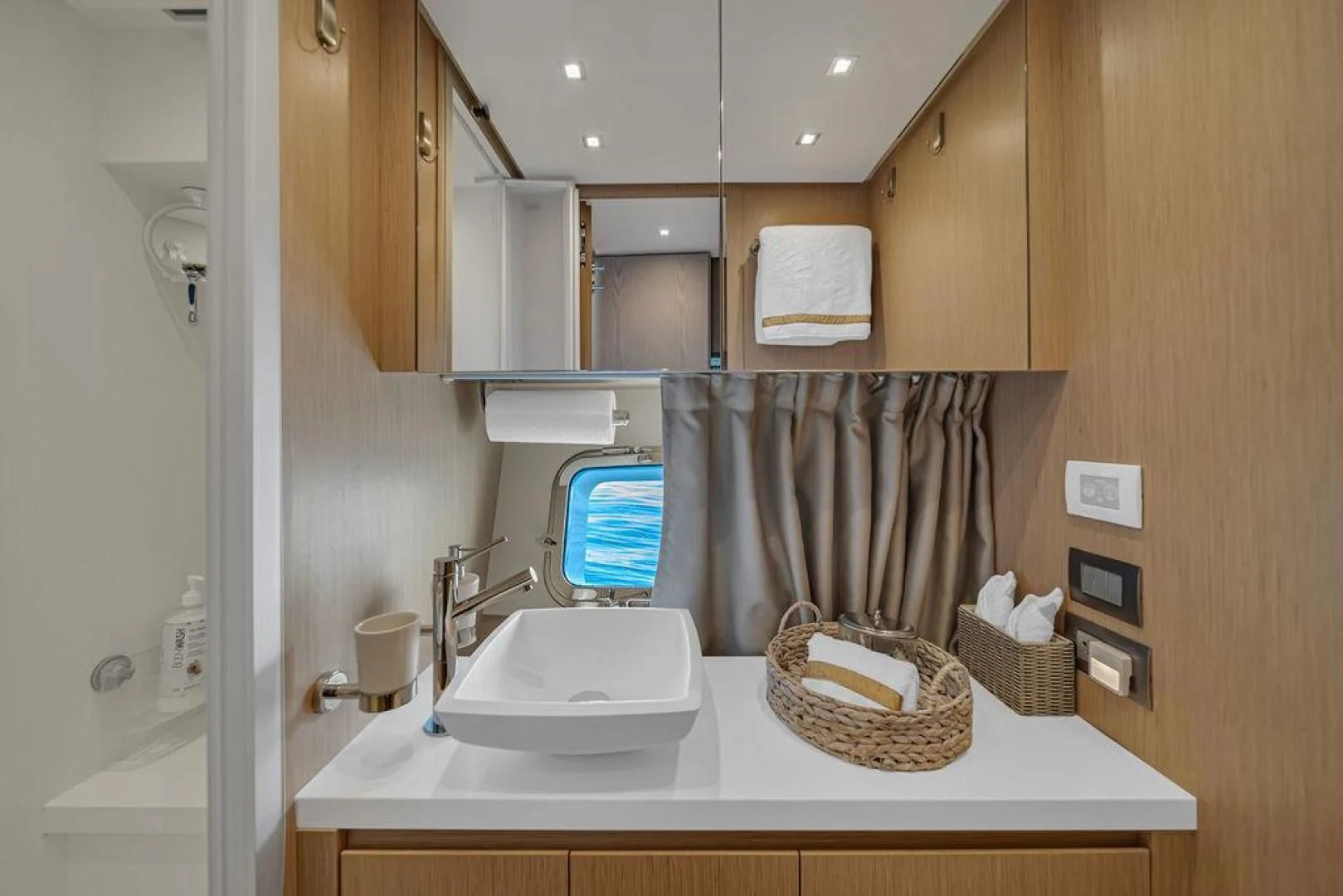 a bathroom with a basket aboard JUJU Yacht for Sale
