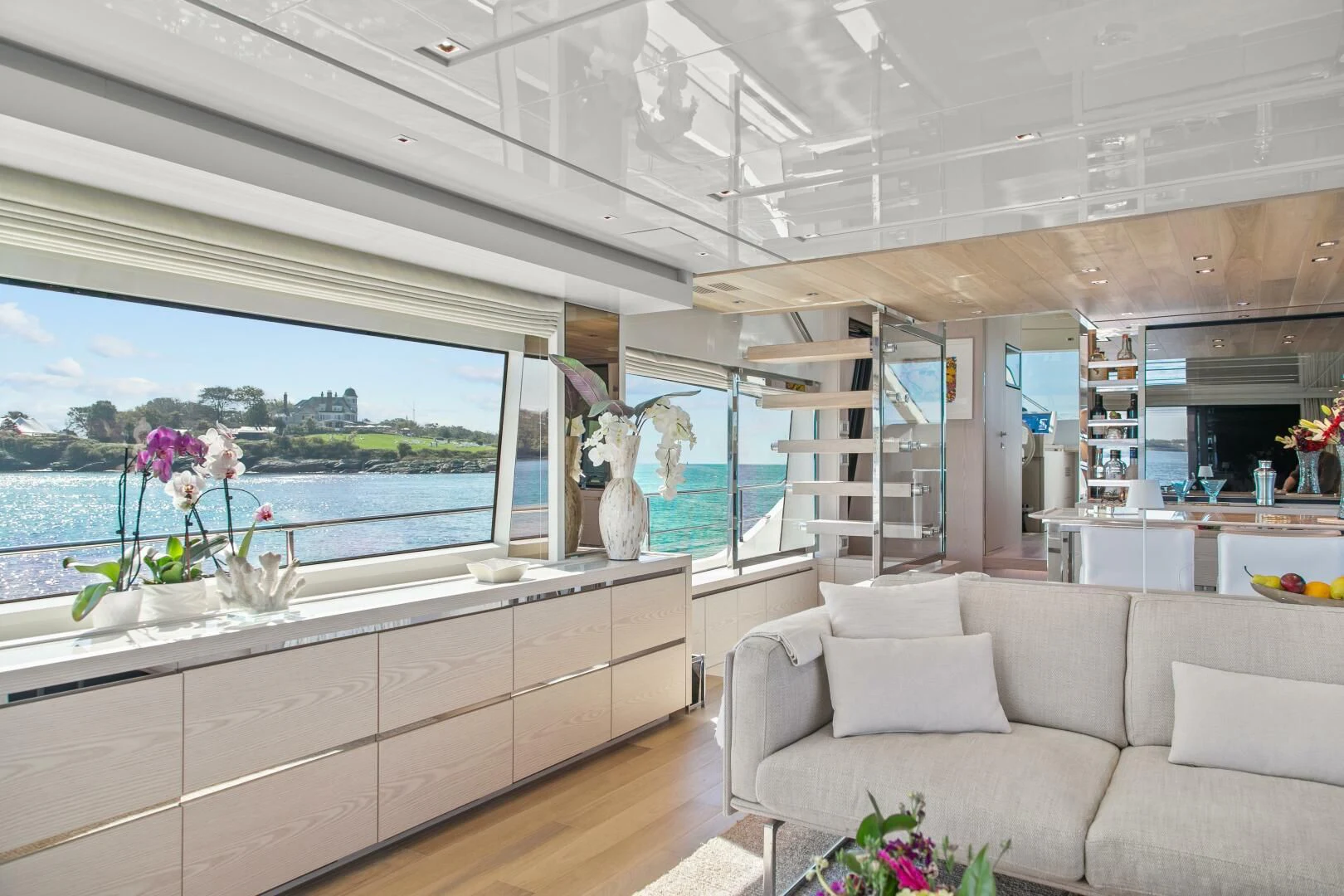 a room with a couch and a table with flowers aboard JUJU Yacht for Sale