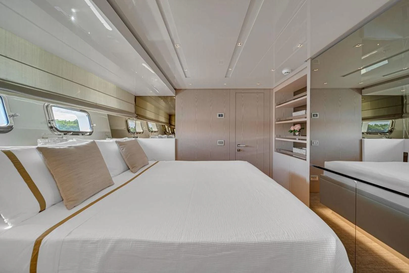 a room with a bed and a mirror aboard JUJU Yacht for Sale