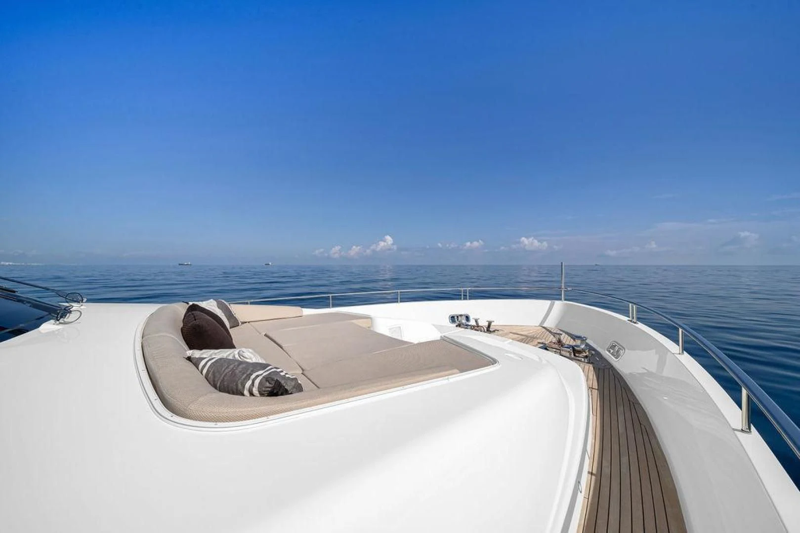 a person lying on a deck overlooking the ocean aboard JUJU Yacht for Sale
