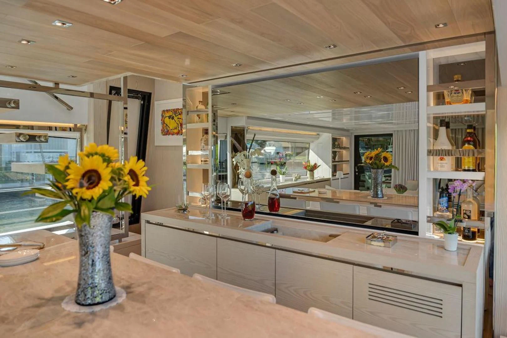 a kitchen with a vase of yellow flowers aboard JUJU Yacht for Sale