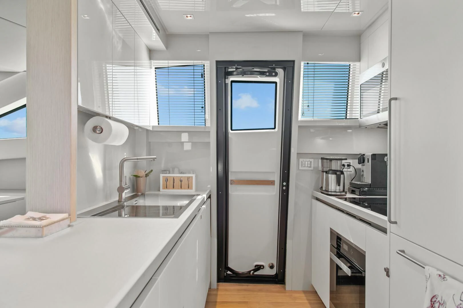 a kitchen with a sink and a refrigerator aboard JUJU Yacht for Sale