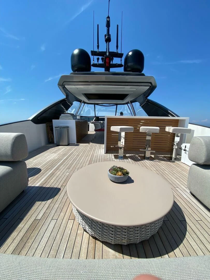 a round table with chairs around it aboard JUJU Yacht for Sale