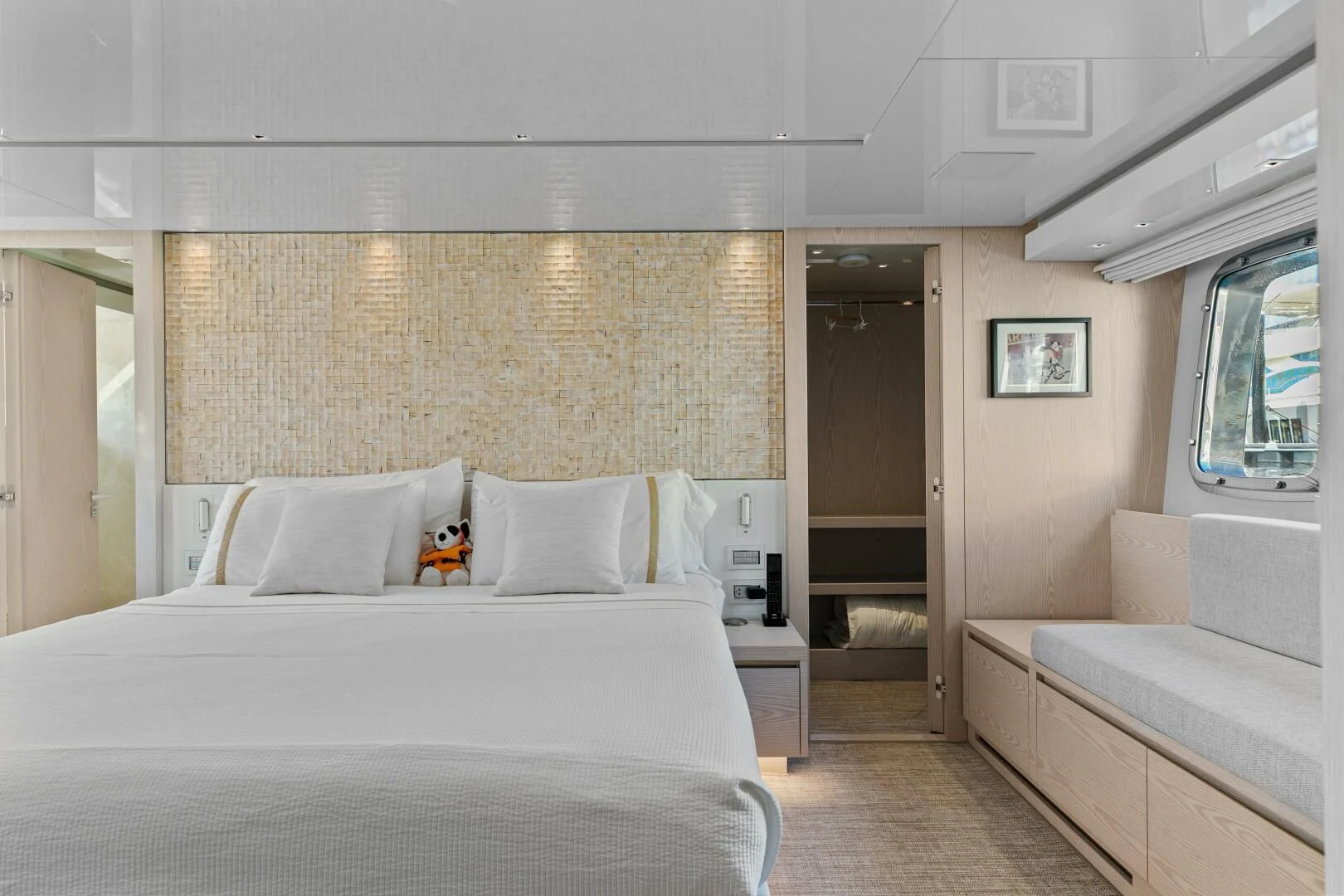 a bedroom with a bed and a couch aboard JUJU Yacht for Sale