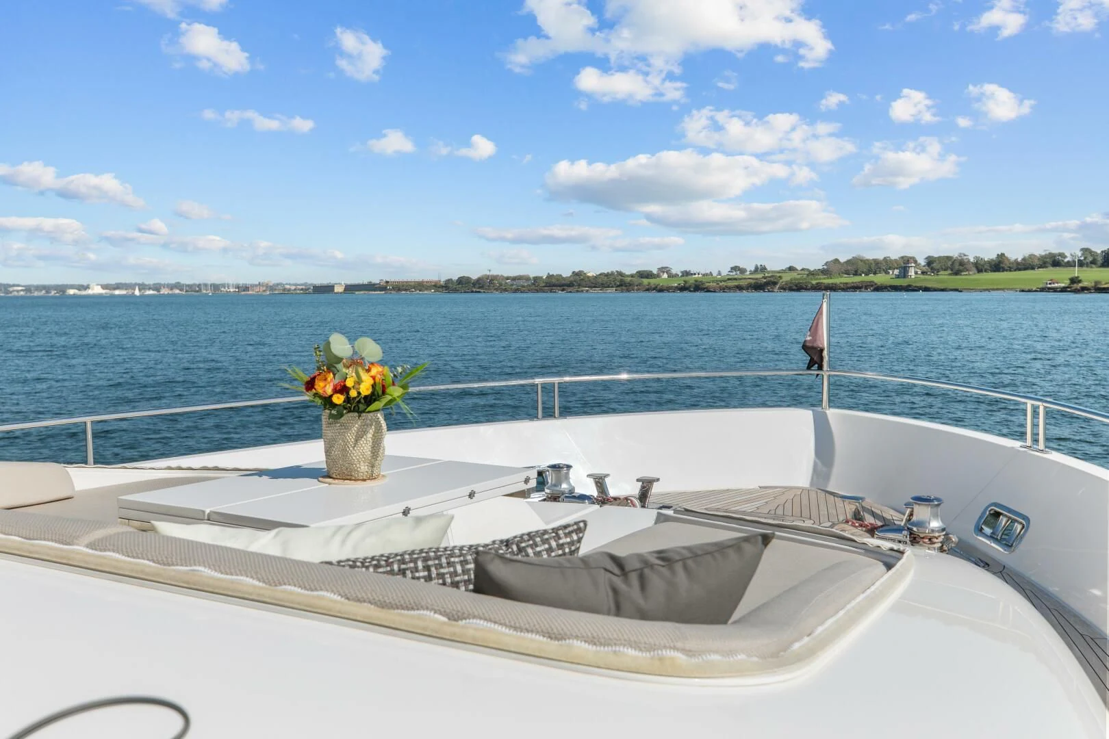 a boat with a flower pot on it in the water aboard JUJU Yacht for Sale