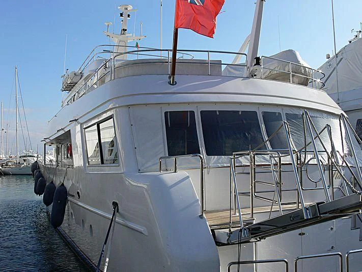 a white boat with a red and black flag on it aboard STAR OF THE SEA Yacht for Sale