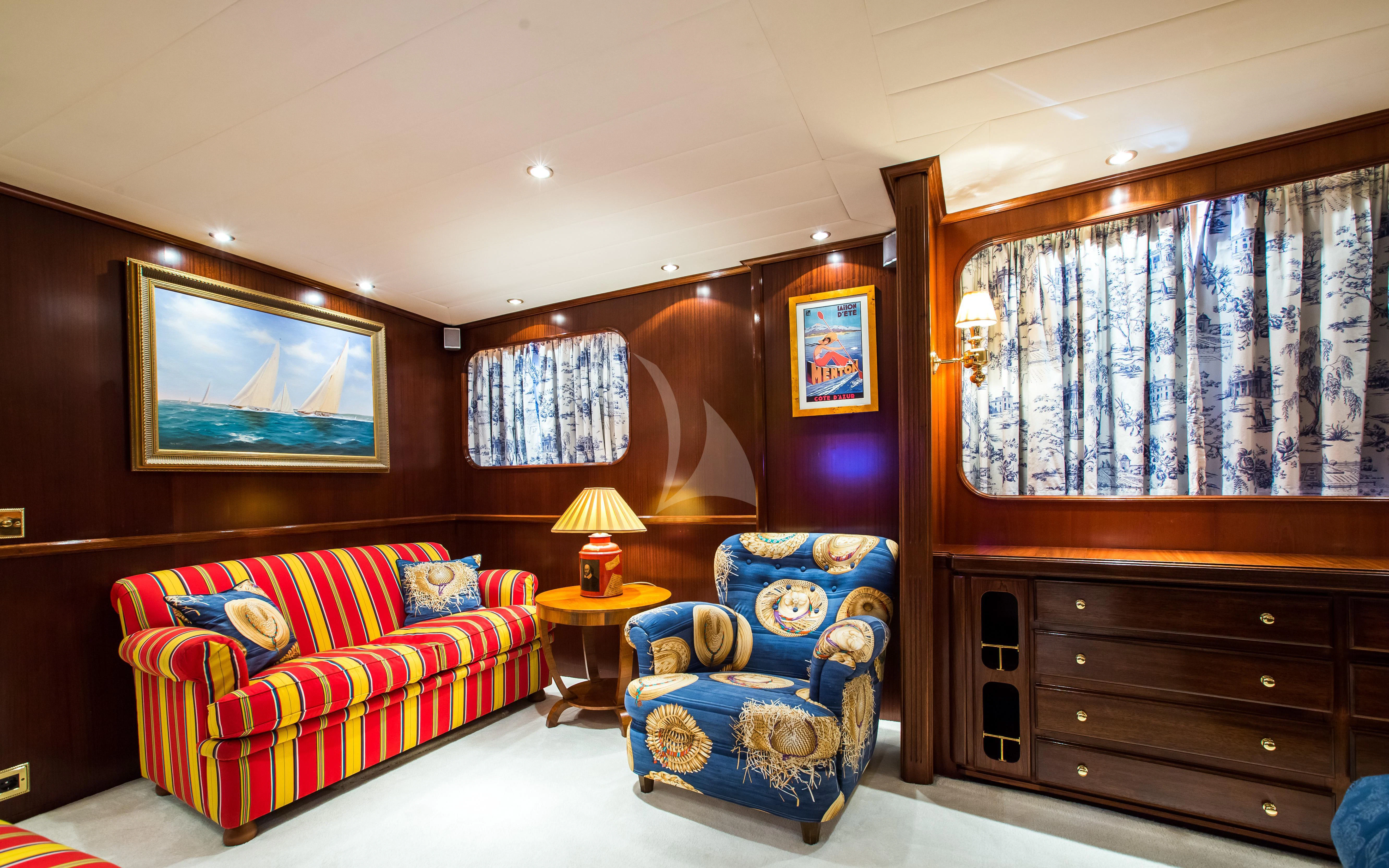 a living room with a couch and a chair aboard STAR OF THE SEA Yacht for Sale