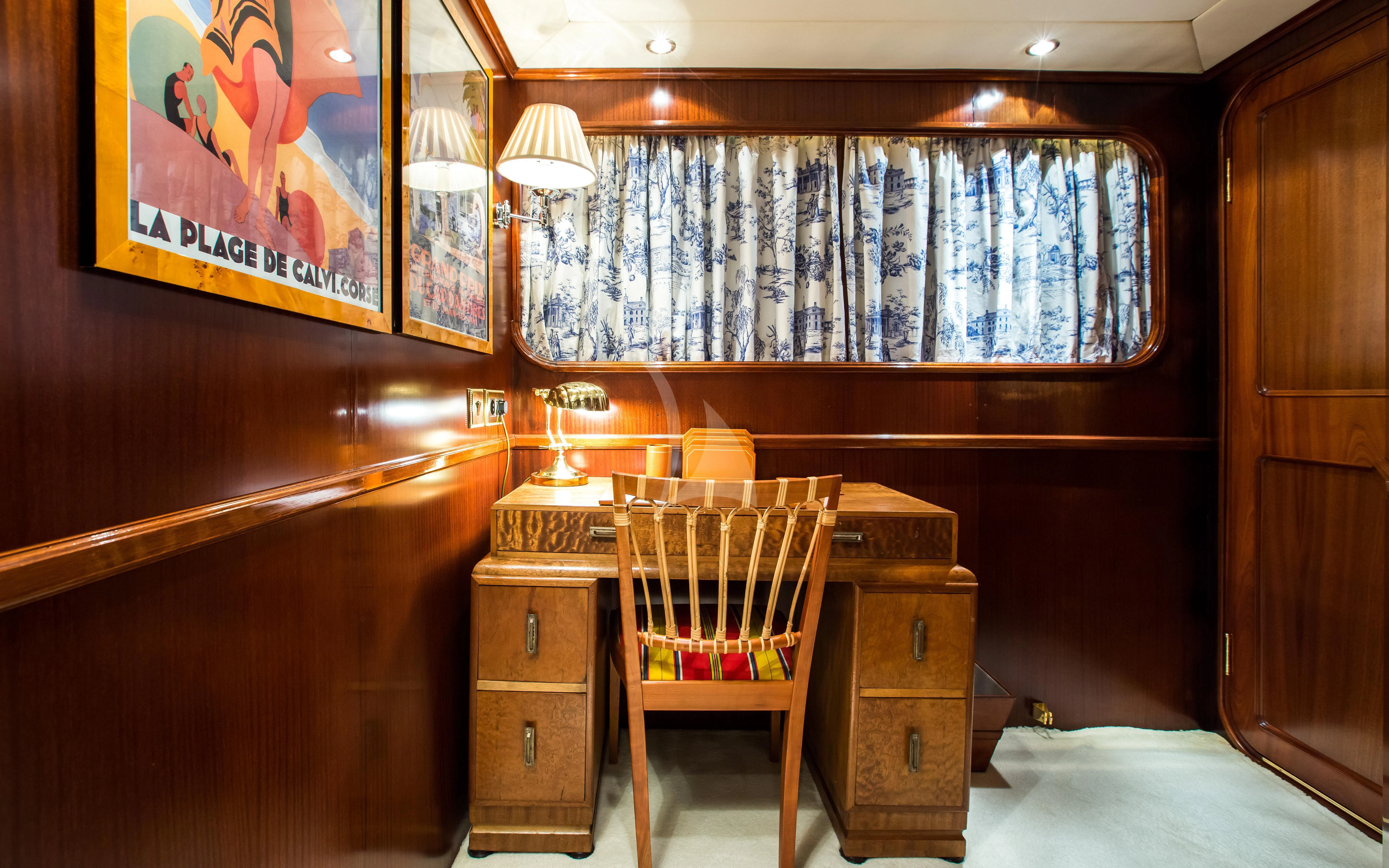 a room with a table and a chair aboard STAR OF THE SEA Yacht for Sale