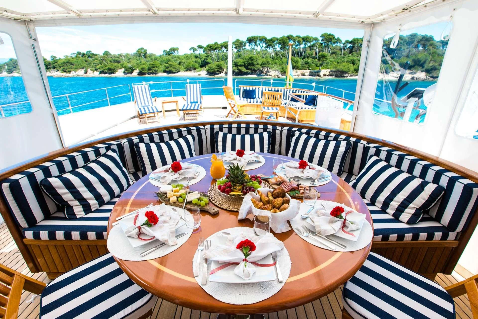 a table set for a meal on a deck aboard STAR OF THE SEA Yacht for Sale