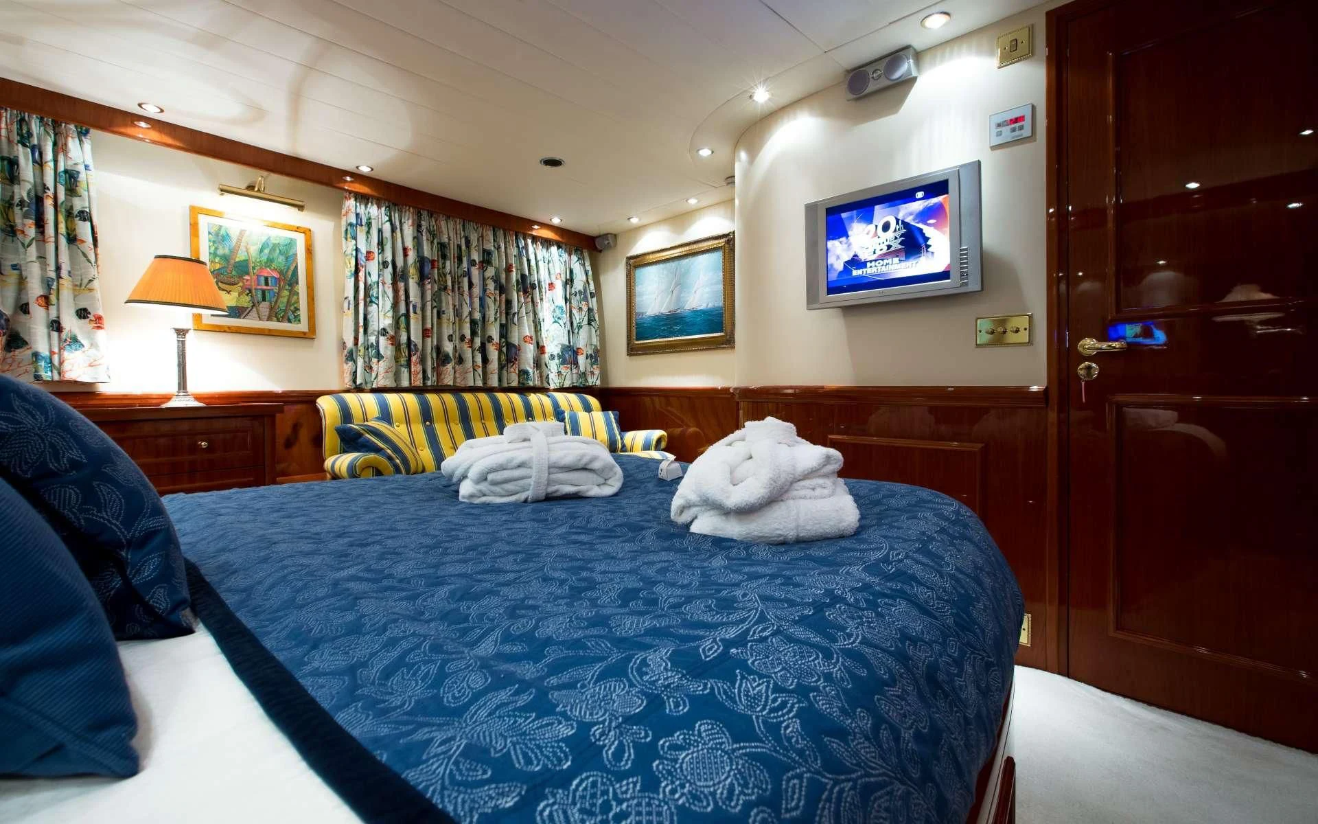 a bedroom with a bed and a television aboard STAR OF THE SEA Yacht for Sale
