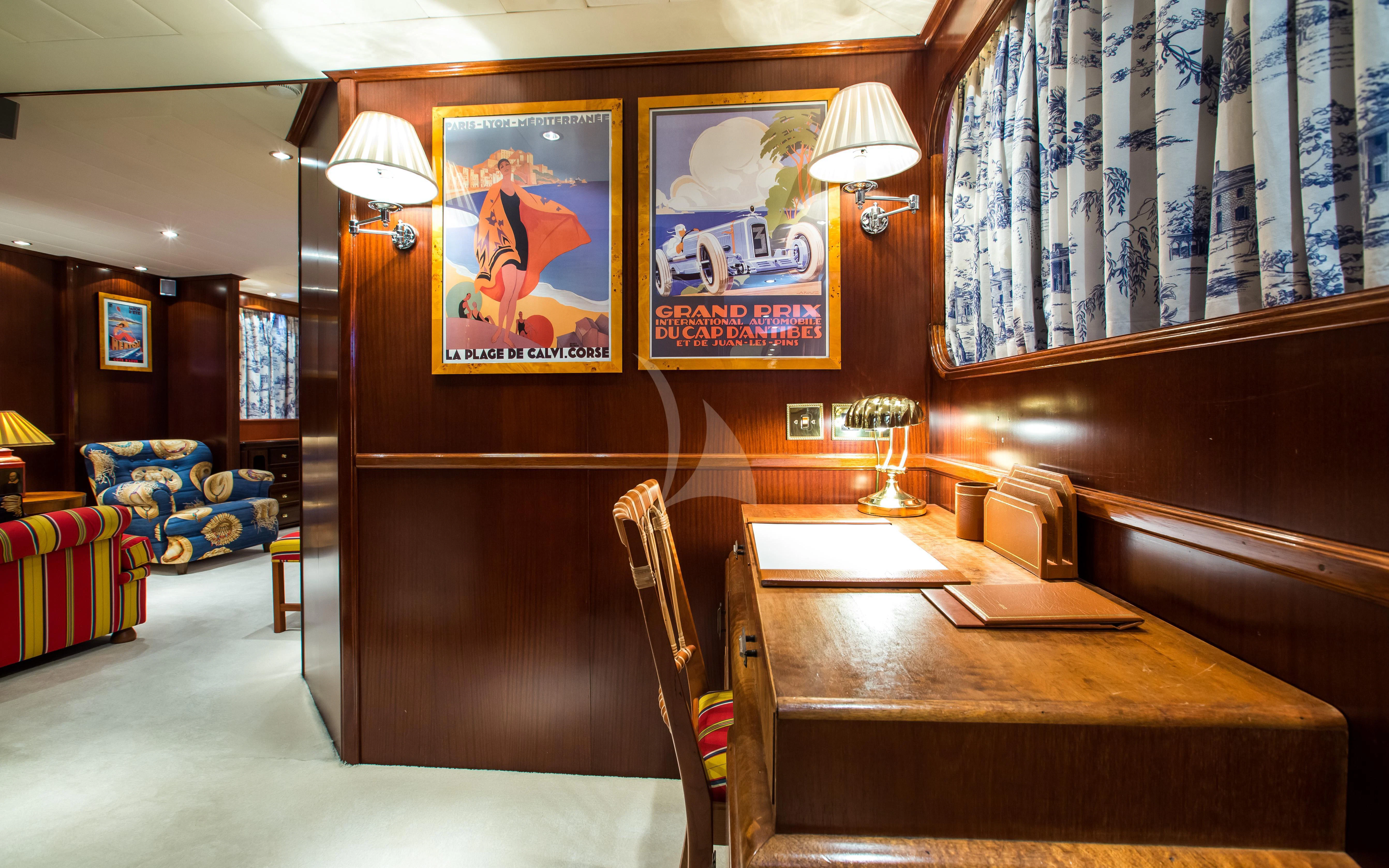 a room with a desk and a bed aboard STAR OF THE SEA Yacht for Sale