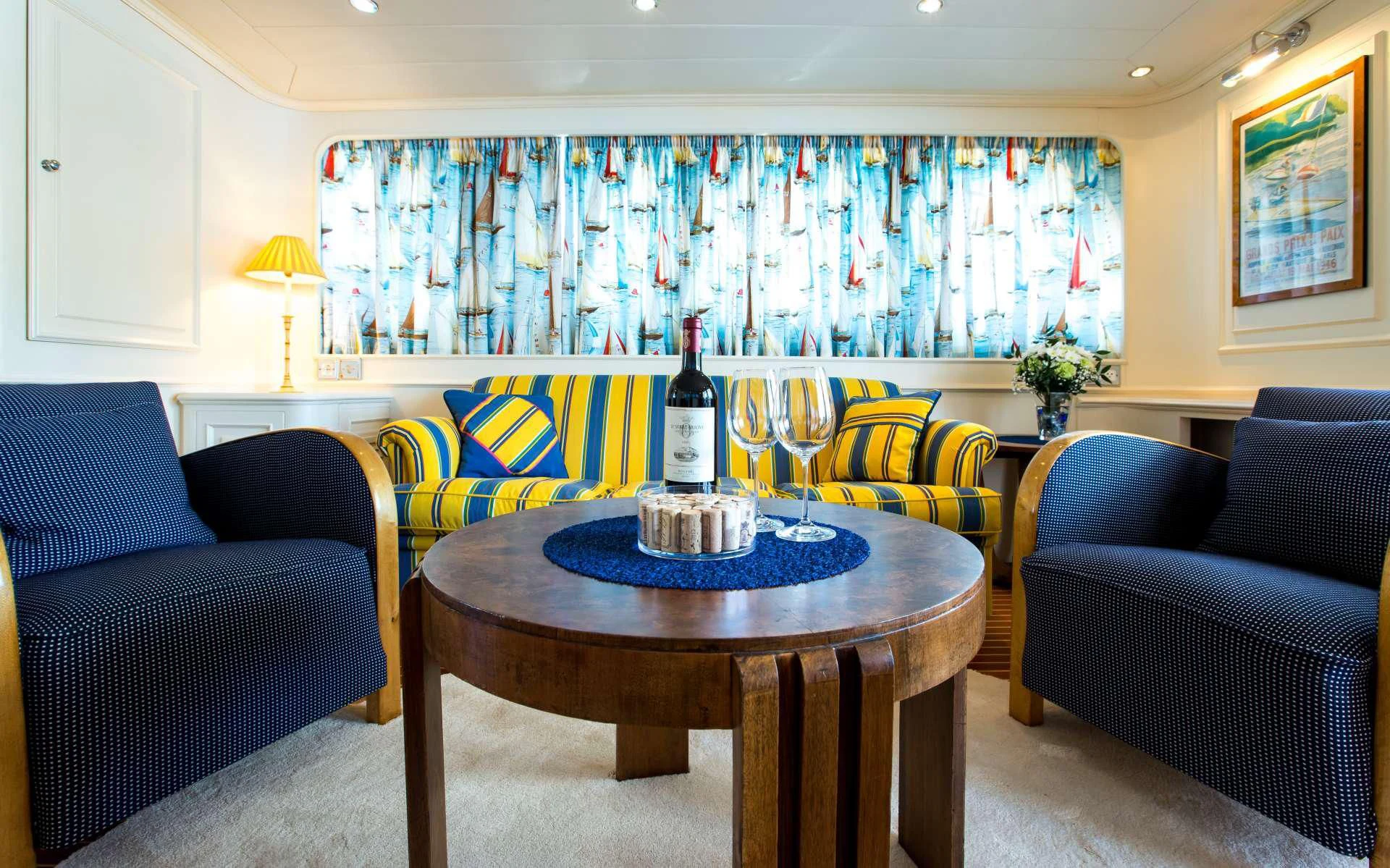 a wine bottle on a table aboard STAR OF THE SEA Yacht for Sale