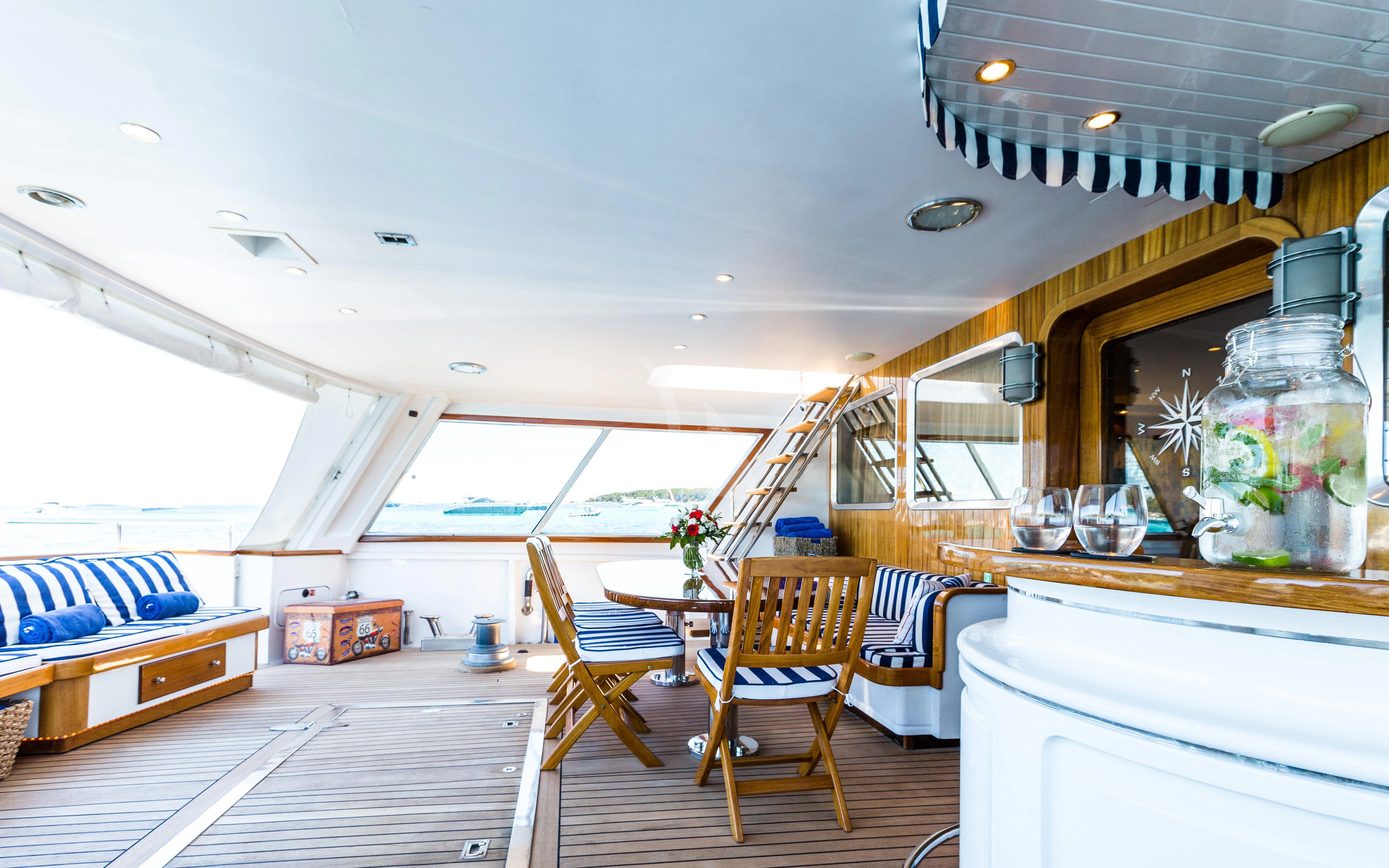a room with a table chairs and a large window aboard STAR OF THE SEA Yacht for Sale
