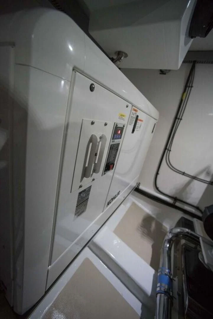 a white refrigerator in a kitchen aboard GRACIE Yacht for Sale
