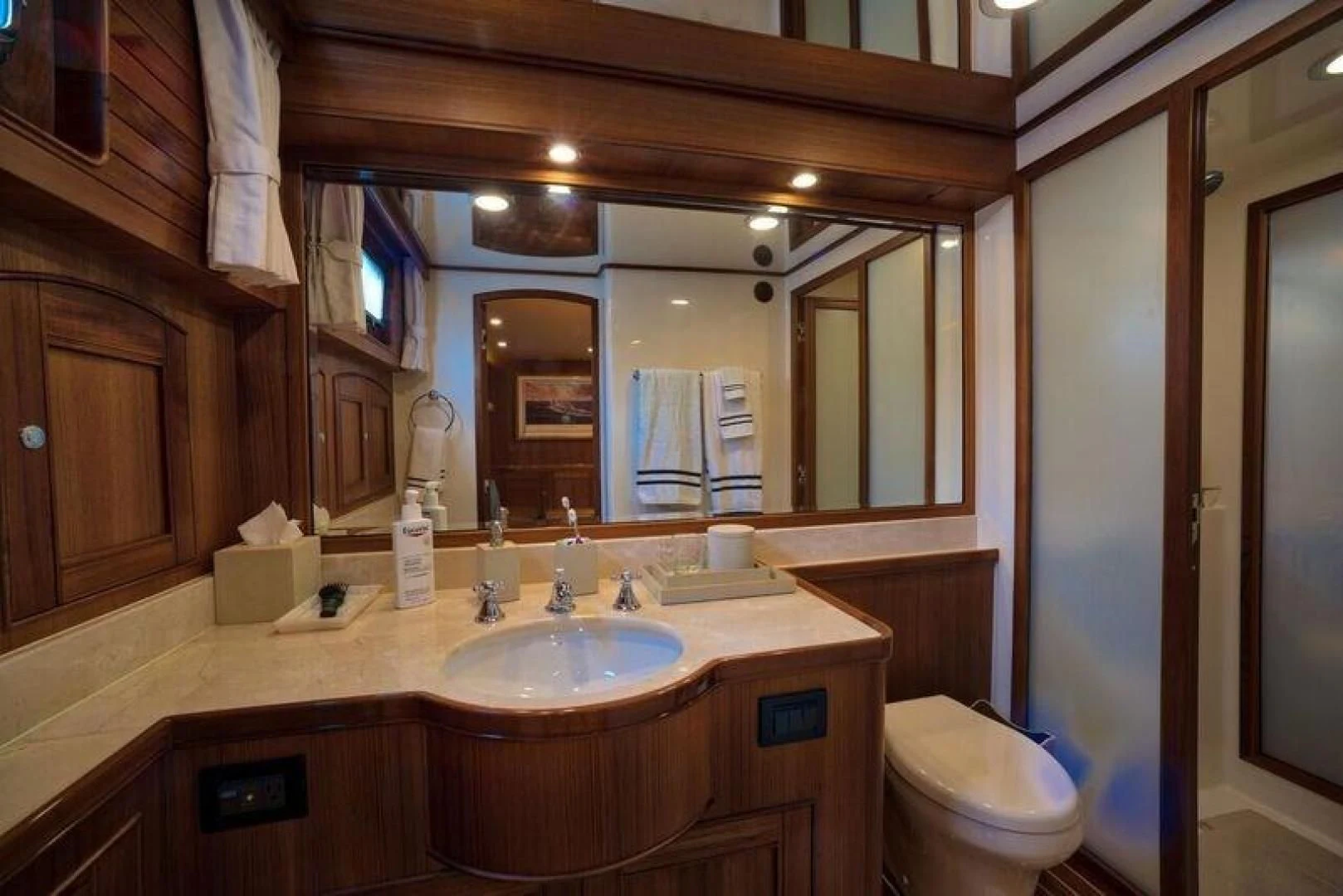 a bathroom with a large mirror aboard GRACIE Yacht for Sale