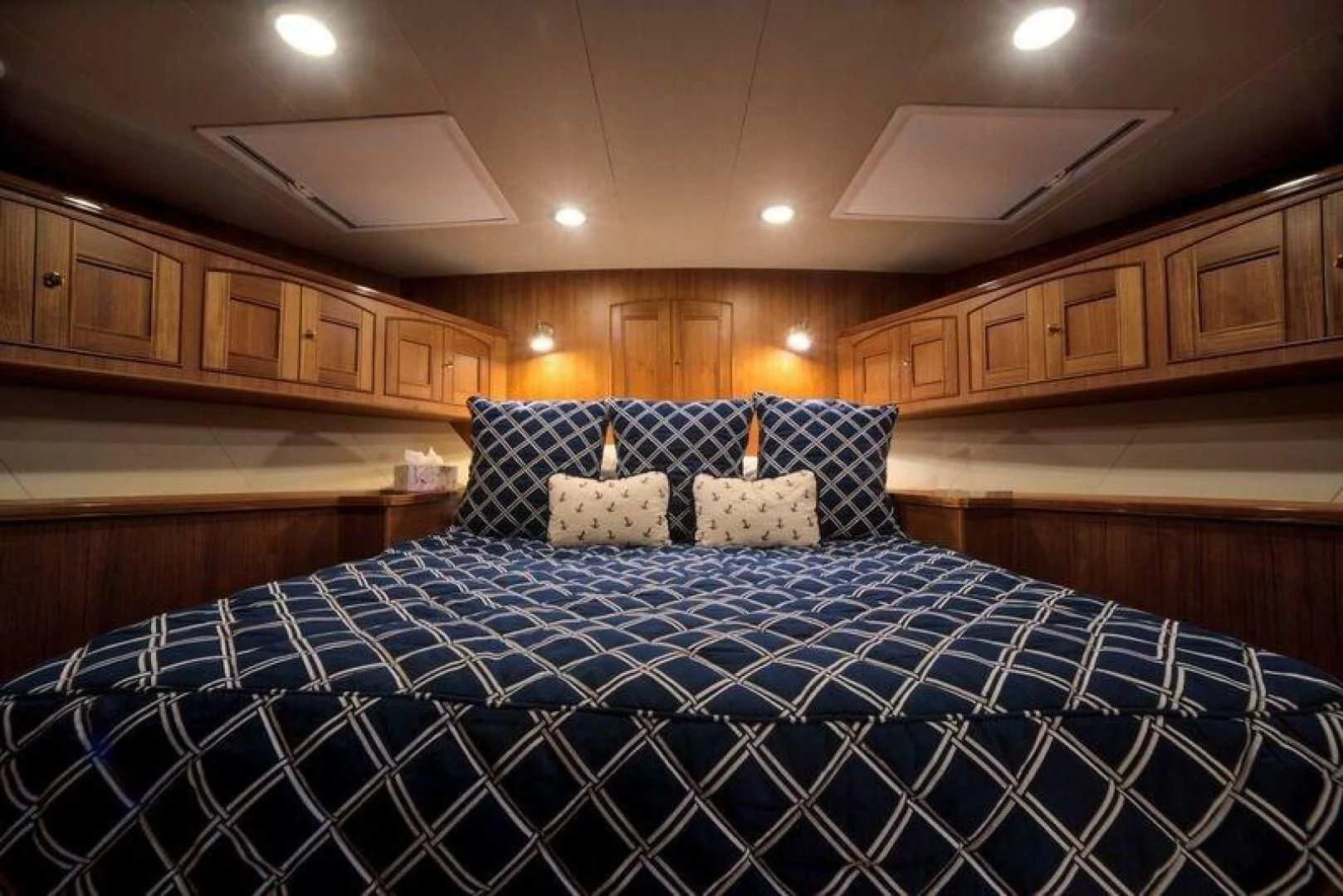 a bed with blue sheets aboard GRACIE Yacht for Sale