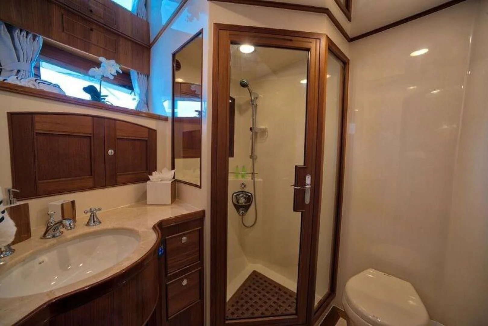a bathroom with a shower and sink aboard GRACIE Yacht for Sale