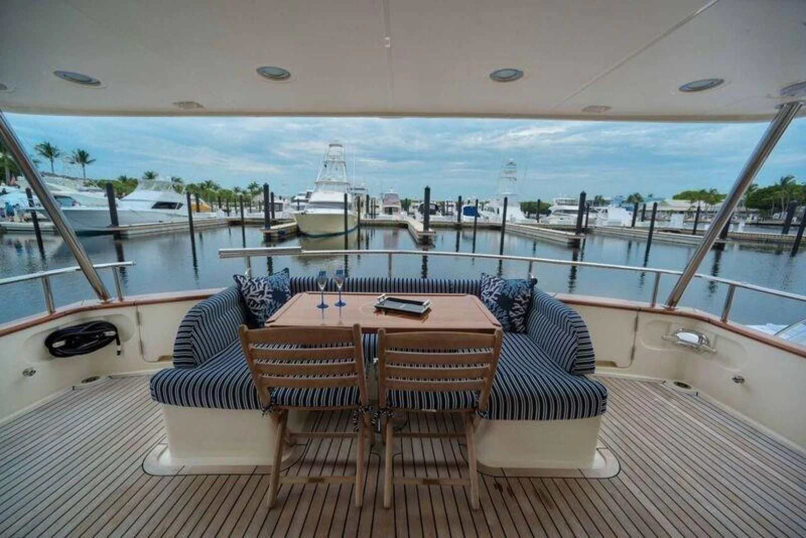 a table and chairs on a deck overlooking a large body of water aboard GRACIE Yacht for Sale