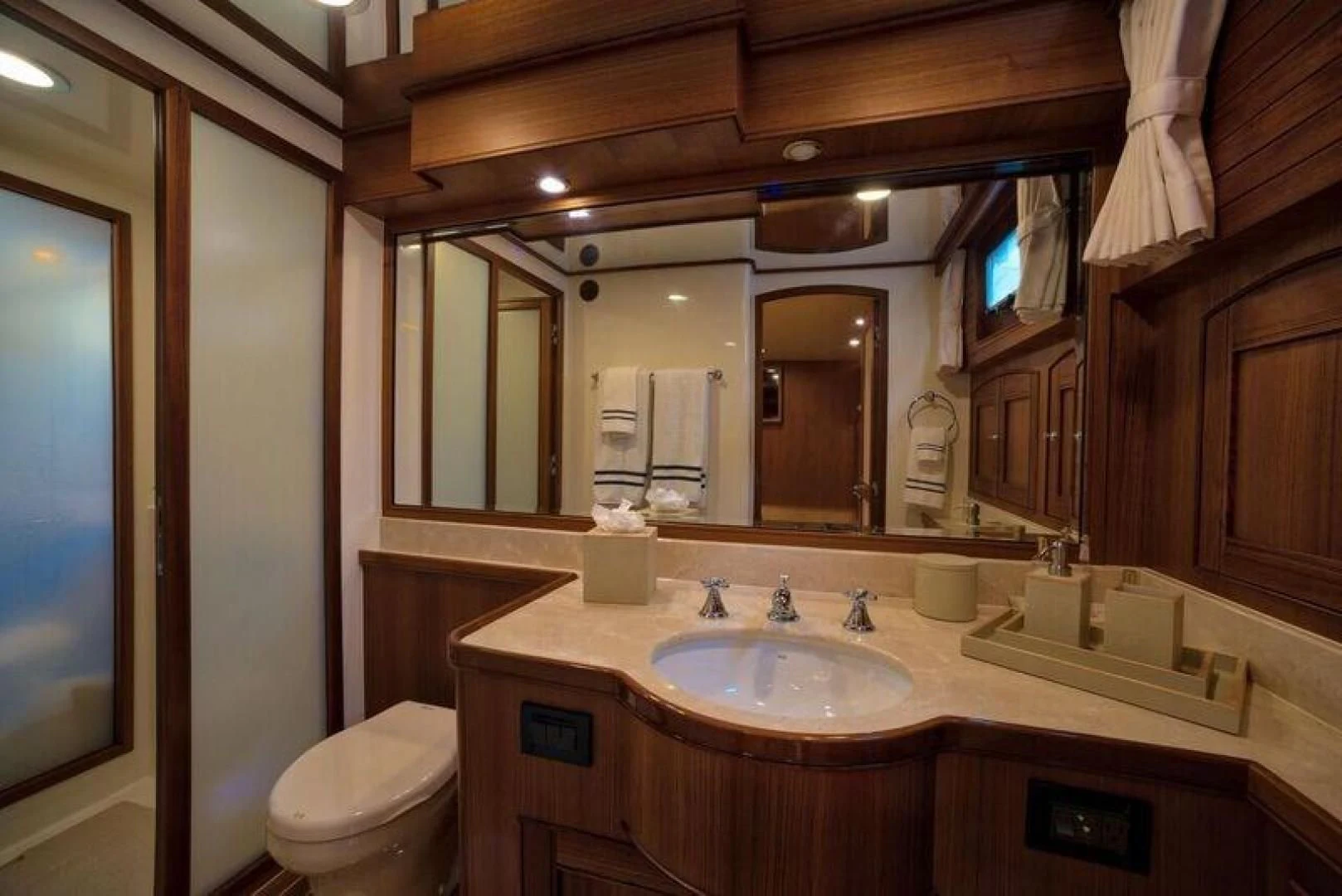 a bathroom with a large mirror aboard GRACIE Yacht for Sale