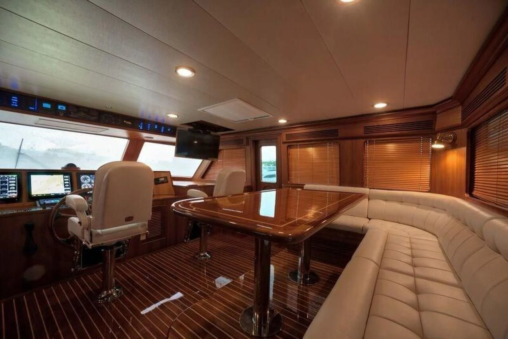 a room with a table and chairs aboard GRACIE Yacht for Sale