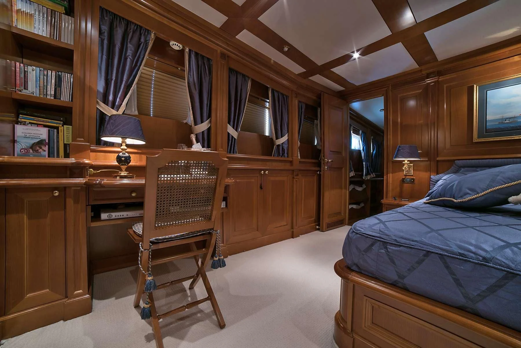 a bedroom with a desk and a bed aboard ANNE MARIE Yacht for Sale
