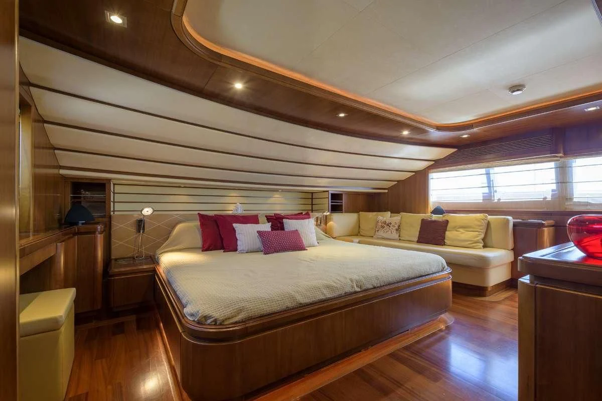 a bedroom with a bed and a window aboard ANNE MARIE Yacht for Sale