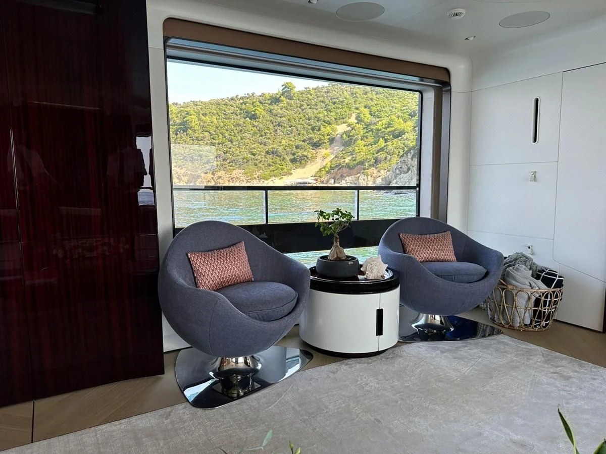 a living room with a large window aboard NG Yacht for Sale