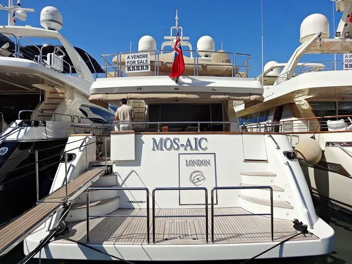 a boat with a flag on the deck aboard MOS-AIC Yacht for Sale